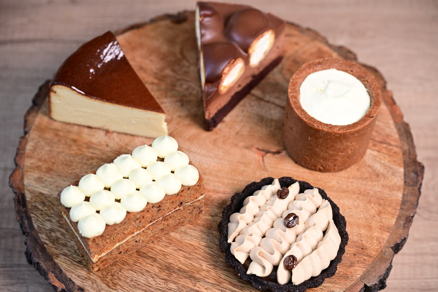 A hot cappuccino with latte art next to a cookie and creative supplies